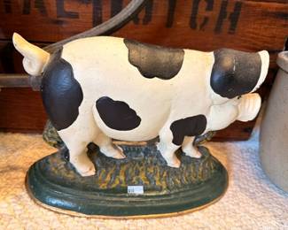 Vintage cast iron cow doorstop, black and white spotted, painted green base