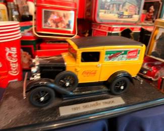 Coca-Cola die-cast delivery truck model on display base, vintage Coke toy truck collectible
