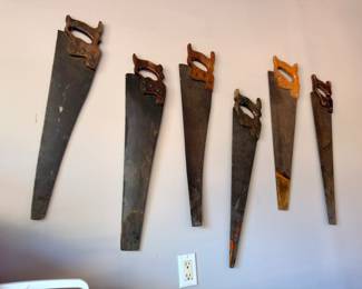 Antique hand saw collection lot, vintage woodworking tools, rustic primitive saws display