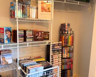 DVDs, VHS tapes, books, media collection on wire closet shelving lot