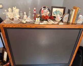 Flat screen TV on console, figurines, crystal glassware, collector plates, home decor lot