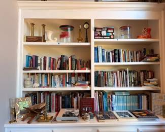 Built-in bookcase loaded with books, vintage collectibles, and antiques