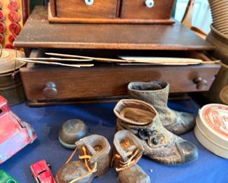 Antique baby shoes, wooden spice cabinet with drawers, small collectibles
