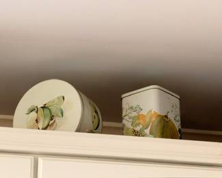 Decorative plate and floral ceramic canister on white cabinet, vintage kitchen pottery accents