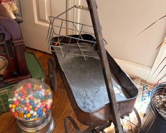 Antique coal scuttle with shovel, vintage gumball machine, wire basket cart