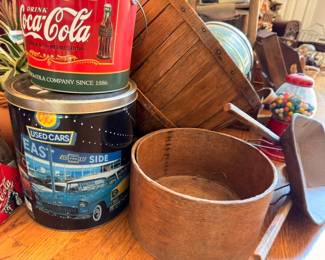 Coca-Cola collectible tin, vintage gumball machine, wooden barrel, East Side Used Cars sign