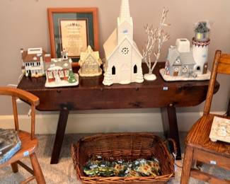 Ceramic Christmas village church houses, framed art, wicker basket, holiday decor table
