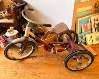 Antique child's red tricycle with metal wheels, vintage toy collectible