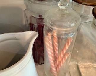 Glass apothecary jar with lid, candy canes, white ceramic pitcher, kitchen counter decor