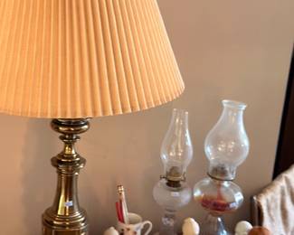 Brass table lamp with pleated shade, glass oil lamp, figurines, dresser top decor