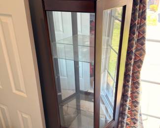 Tall glass curio display cabinet, wood frame, glass panes, collectible showcase