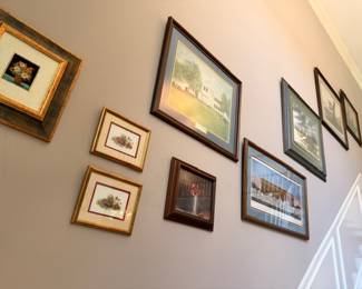 Gallery wall of framed paintings and prints, assorted landscapes and still lifes, gilt frames