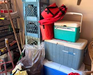 Coolers wire rack storage bins, garage camping gear lot, outdoor equipment collection