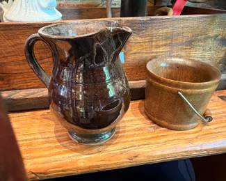 Brown glazed pottery pitcher with grape design, turned wooden bowl