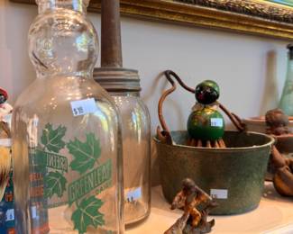 Antique glass butter churn jar with dasher, copper ladle, painted ceramic figurine