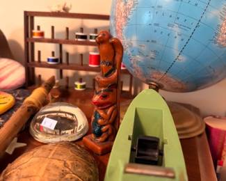 Vintage world globe on stand, carved wooden figurines, collectible decor lot