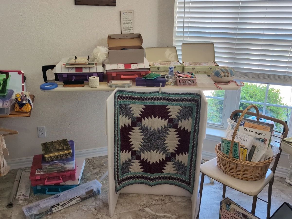 Quilting supplies, including patterns, thread, and unfinished projects.