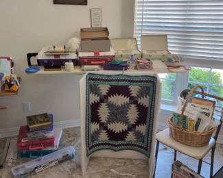 Quilting supplies, including patterns, thread, and unfinished projects.