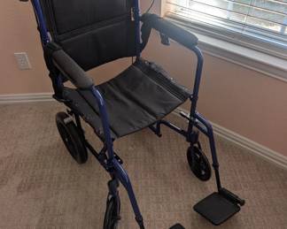 Transport chair by Drive. 15lbs,, removable foot pedals, foldable. In excellent condition