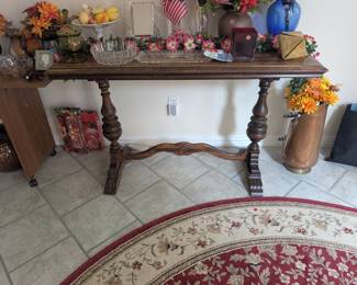 Antique trestle table and 6' diameter round Oriental rug.