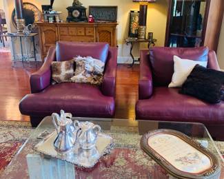 leather chairs, Brutalist style coffee table and notice the 7 ft tall antique  French display cabinet