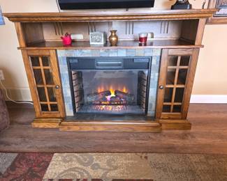 The product is a ClassicFlame Lakeland Media Console Electric Fireplace, featuring a premium oak finish, slate surround, and glass panel doors.