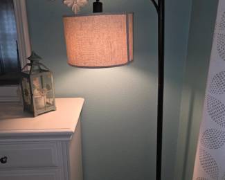 likely an EDISHINE modern arc floor lamp featuring a black metal body, a circular base, and a beige linen drum shade.