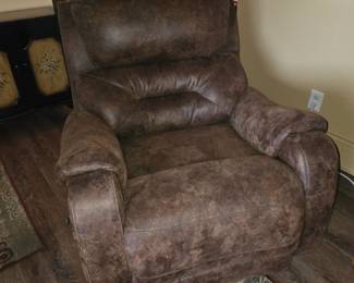 This item appears to be a brown faux leather rocker recliner similar in style to the Franklin Furniture Dakota Rocker Recliner.