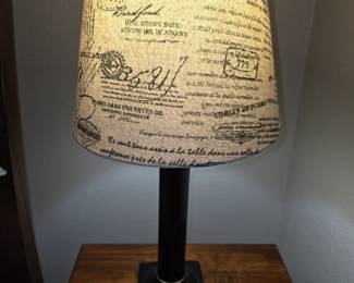 This table lamp is an allen + roth Tan with Black Script Fabric Drum Lamp Shade paired with a black lamp base.