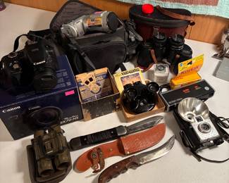 Vintage cameras, binoculars and knives. The canon camera is actually a powershot SX50 HS in a SX70 HS box.
