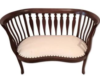 Antique Spindle Back Settee with Cream Colored Cushion