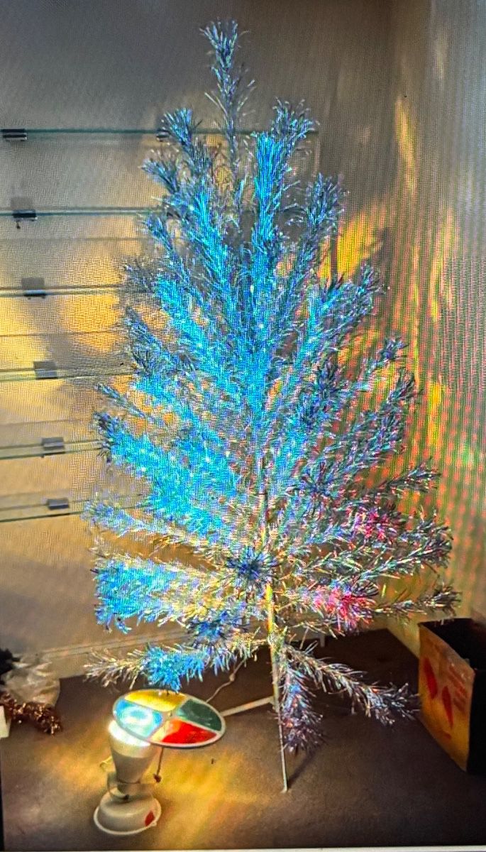 The most INCREDIBLE vintage aluminum tree and original light. Original sleeves for branches. This one is $500 firm.