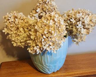 Blue vase with cream colored floral arrangement
