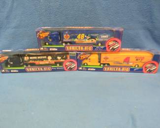 Lot 111. Three Winner's Circle 1:64 scale die-cast trucks: Tony Stewart, Jimmie Johnson, and Mike Skinner.