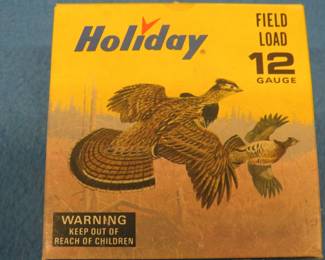 Lot 211. Vintage Holiday 12-gauge shotgun shell box with Les Kouba Ruffed Grouse and Rabbit in excellent condition. The box contains 25 9-shot shotgun shells in AA hulls which may be reloads. AS-IS. Use at your own risk.