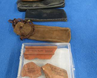 Lot 131. Five leather harmonica bags and souvenir chunks of brick from three different old harmonica factories in Germany