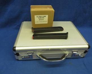 Lot 95. Two 32-round Amend2 9mm magazines, a hard pistol case, and a case of gun lube