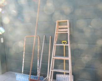 Lot 161. Four snow shovels, one pusher pole for watercraft, and a wooden 6' step ladder.