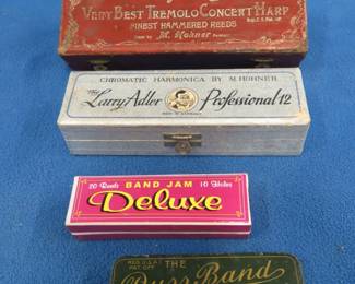 Lot 73. Four empty harmonica boxes: 7 5/8" long M. Horner The Up To Date Very Best Tremolo Concert HARP. 6 1/2" M. Hohner The Larry Adler Professional 12. 4 1/8" long The Duss Band Professional Harmonica hinged tin box. 4 1/4" Band Jam deluxe