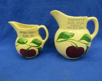 Lot 309. Two advertising Watt Ware apple pattern pitchers. Rush City Minnesota and Arthur Farmers Elevator.