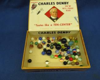 Lot 260. Marbles including shooters and clay marbles in a Charles Denby cigar box