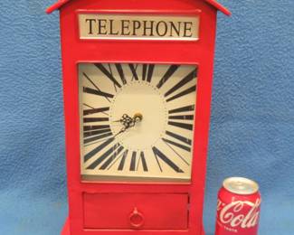 Lot 278. Battery-operated clock in a phone booth setting