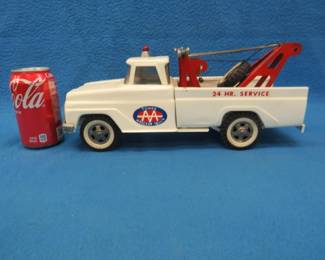 Lot 127. Vintage 1960s Tonka pressed steel wrecker/tow truck in excellent condition with door decal: Tonka AA Wrecker Truck. 14" long x 6" high x 5 1/4" wide. Paint and parts are all original including the cab light and spare tire.