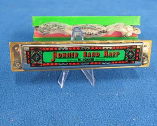 Lot 137. Hohner Band Harp diatonic 32-hole harmonica with box and paper in like-new condition. Sounds great.
