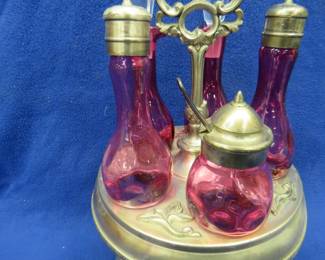 Lot 310. Complete Cranberry Glass cruet set in very good condition