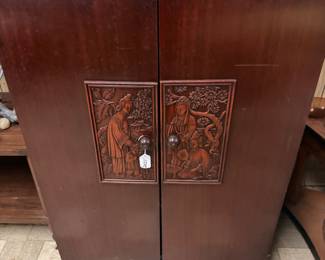Storage cabinet with Asian relief work