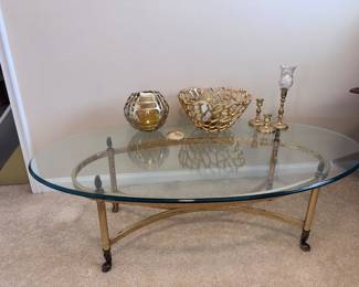Brass base and oval glass top coffee table