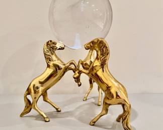 Trio of "gold" horses balancing glass orb
