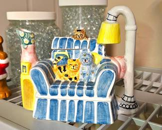 Vintage teapot shaped ceramic sofa with cats.