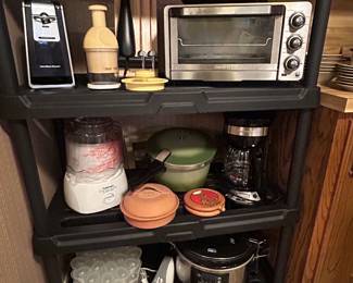 All manner of kitchen appliances including a vintage Presto pressure cooker, crockpot, coffee pot, toaster oven, ice cream machine